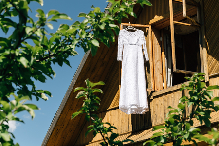 hanging bride's dress, wooden houseの写真素材