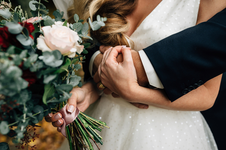 the bridegroom embraces the bride, autumnの写真素材