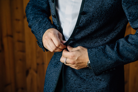 the man zips up his blue jacketの写真素材