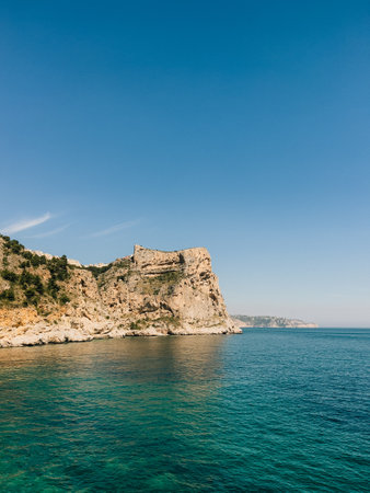 Enjoy a beautiful and scenic coastal view featuring stunning cliffs and crystal clear watersの写真素材