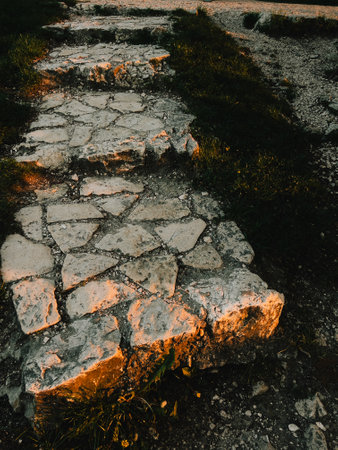 Stone paved path illuminated by golden sunset light. Warm sunlight illuminating a stone paved path...