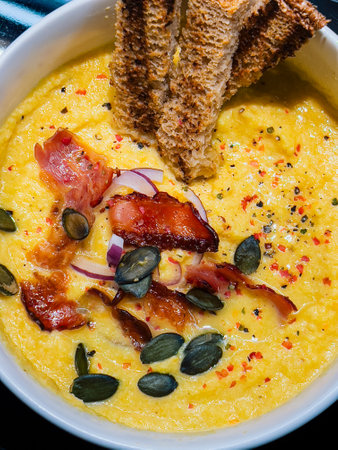 Nutritious fall soup with grain toast and seeds, nutritious details reflect modern eating, hearty bowl of cozy soupの写真素材