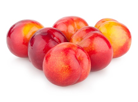 red plums isolated on whiteの写真素材