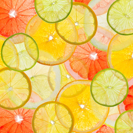 Colorful fruit background made of citrus slicesの写真素材