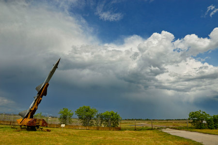 Abandoned rocket launcher in the field with a dramatic sky.の写真素材