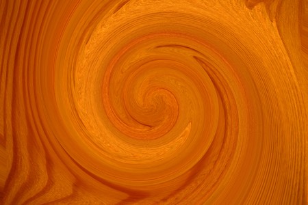 Background of a fresh planed tree of yellow and light brown color is twisted into a spiralの写真素材
