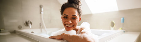 The woman is happily bathing in a jacuzzi tub, smiling with joy