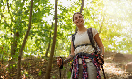A Smiling Hiker Exploring a Vibrant Forest Surrounded by Lush Greenery in Daylightの写真素材