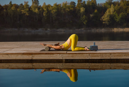 Engaging in Yoga Practice by the Water A Space for Tranquil Reflection and Flexibilityの写真素材