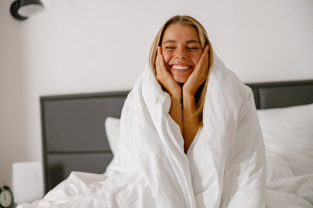 Embracing Joyful Morning Moments Wrapped Comfortably in Cozy Warmth and Happinessの写真素材