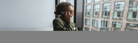 a woman is talking on a cell phone while looking out of a window
