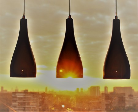 Blade black glasses of sparkling wine in the sky and sun. Retro toned lampshade.の写真素材