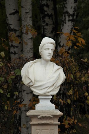 An old sculpture of white marble in the city park.の写真素材