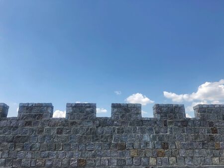 fortified castle wall on background blue sky