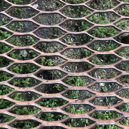 metal grating the background of the earthの写真素材