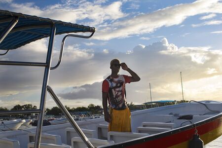 Punta Cana, Dominican Republic - December 09, 2018: boat and sailor on the pier