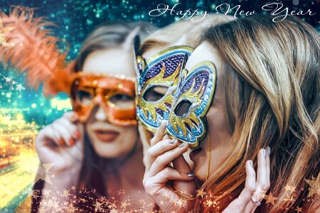 New Year's Eve - young girls in masquerade masksの写真素材