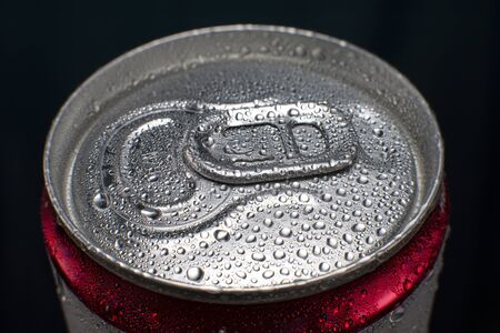 Cooled aluminum can with carbonated drink covered with drops of water condensateの写真素材