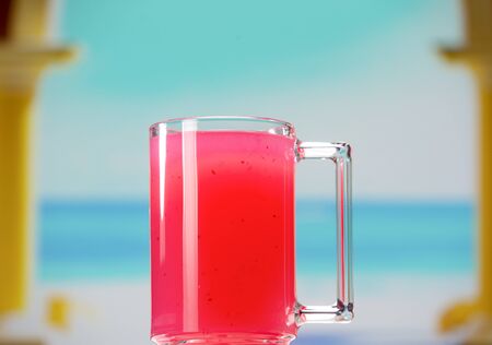 A glass mug with a handle filled with cranberry kissel