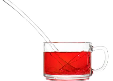 Cup with non-alcoholic cherry punch and glass ladleの写真素材