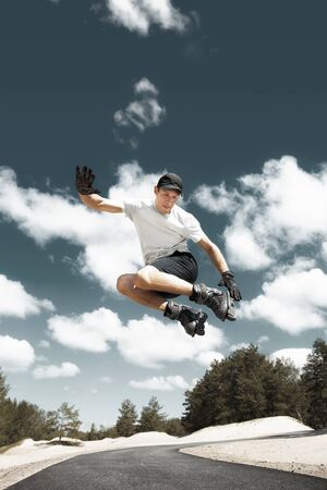 Aggressive inline skating. Young athlete performs tricks during freestyle rolling.