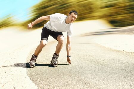 Aggressive inline skating. Young sporty man is rollerbladingの写真素材