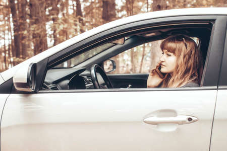 The face of a cheerful girl half hidden by hairの写真素材