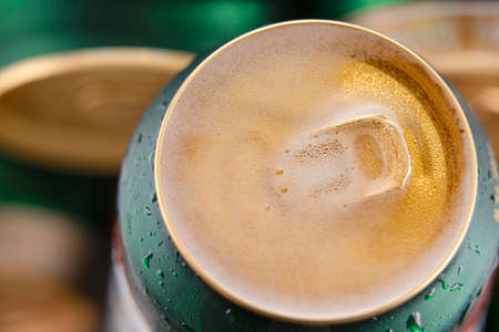 Open beer can with foam on the surface