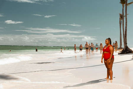 Punta Cana, Dominican Republic - December 07, 2018 - young, smiling black woman on the Arena Gorda beachのeditorial素材