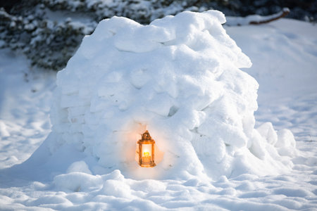 Snow house with a burning kerosene lantern inside