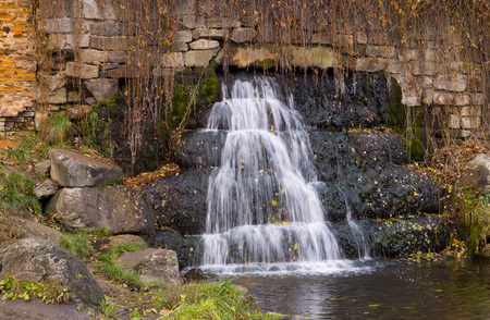 Waterfall on the stones in the autumn seasonの写真素材