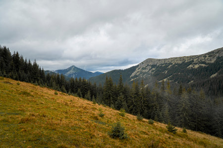 Scenic colorful mountain landscape. View on the Carpathian mountains in the autumn. Clouds in the skyの写真素材