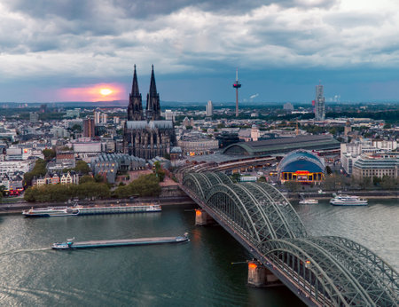 Dramatic thunderclouds over Cologne Cathedral and Hohenzollern Bridge in the eveningの写真素材