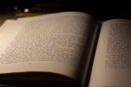 macro photography of a book page with English text, an open book page under artificial light