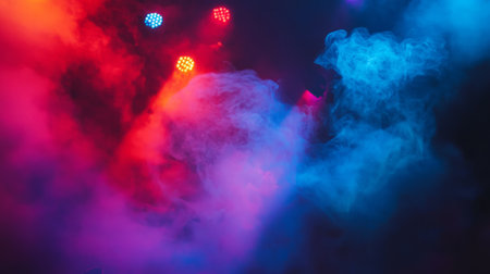 Artificial smoke on a dark stage, illuminated by blue and purple spotlights, creating a dramatic show atmosphereの素材