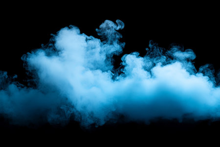 scattered smoke illuminated with blue light on a black backgroundの素材