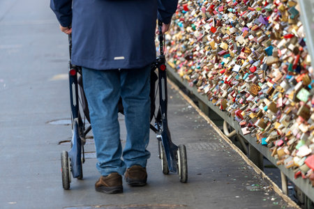 a man with rollators walk across the Hohenzollern Bridge, Cologne Germanyの写真素材