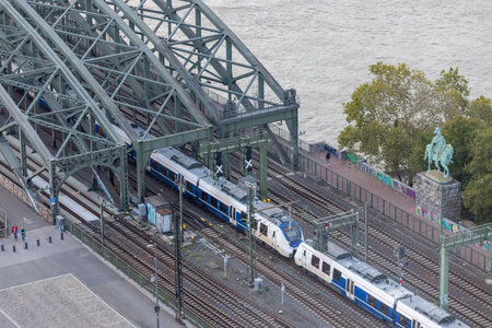 Evening view of Hohenzollern Bridge and moving train in Cologne