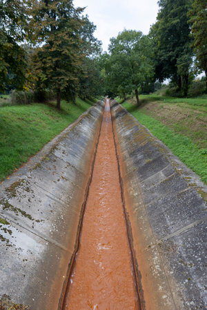 Brown-colored municipal waste drainage water in a concrete collectorの写真素材