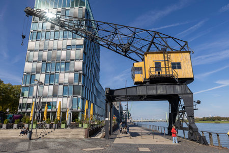 Industrial gantry crane on the banks of the Rhine River for loading and unloading cargo in shipping and logistics.の写真素材