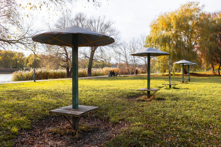 Old iron umbrella awnings stand in a row in the park on a quiet day.の写真素材