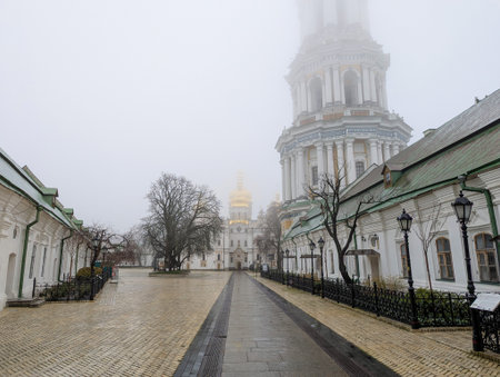Kyiv, Ukraine, November 22, 2025: A view of the Kiev Pechersk Lavra on a cloudy, foggy day, with its...