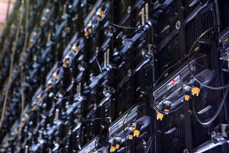 A projection screen stands ready for use, shown from the rear with visible connection ports and cables prepared for setup.の写真素材