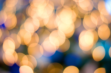 Christmas lights golden and blue bokeh backgroundの写真素材
