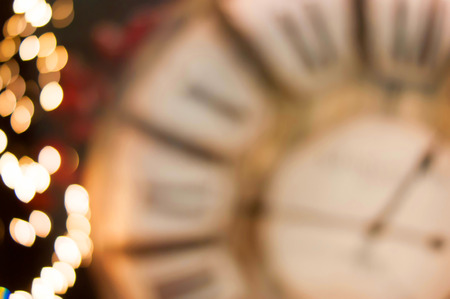 Christmas lights golden background bokeh with clockの写真素材