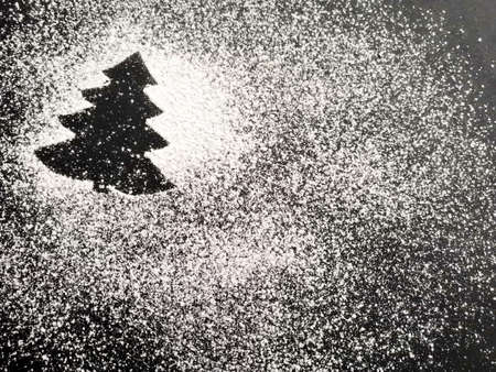 Christmas tree made of flour on a black background. Copy space.の写真素材