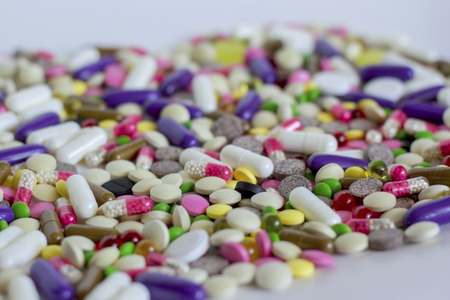 varicoloured drugs scattered on the light surfaceの写真素材