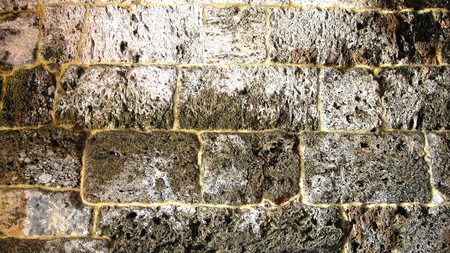 The ancient dilapidatedand cracked relief rocky wall as a backgroundの写真素材