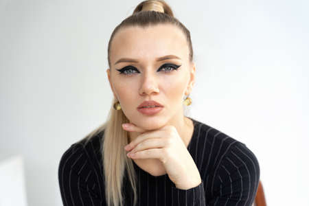 portrait of fashionable blond woman. Young woman with stern look watching us. Passion girlの写真素材