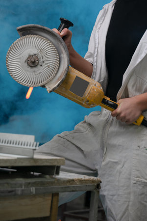girl working in manufacturing industry job using industrial power tool - Maintenance, production and career concept. worker with angle grinder close-up . feminism. plant, factoryの写真素材